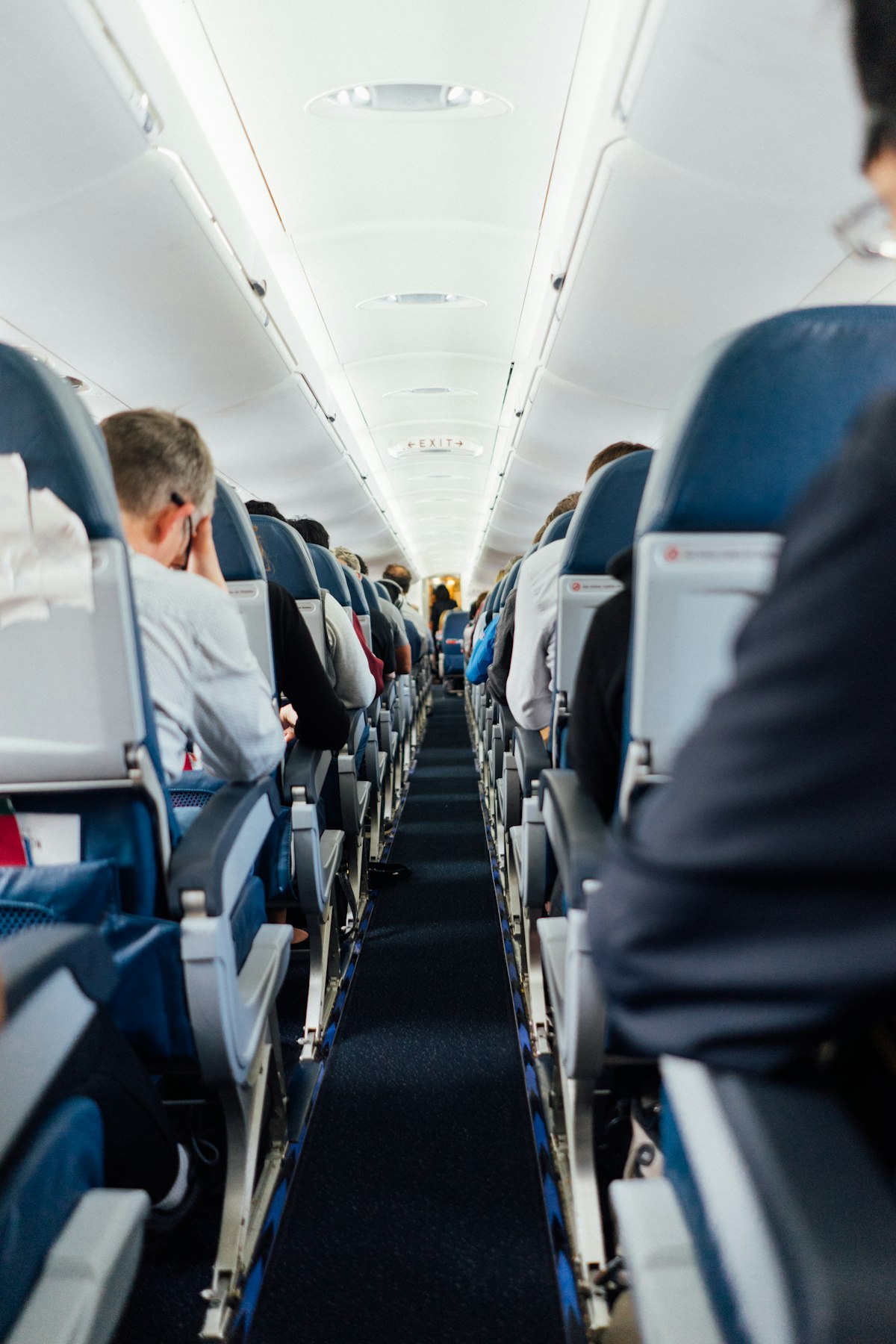 Lie-flat business class suite with the cabin lights dimmed for takeoff